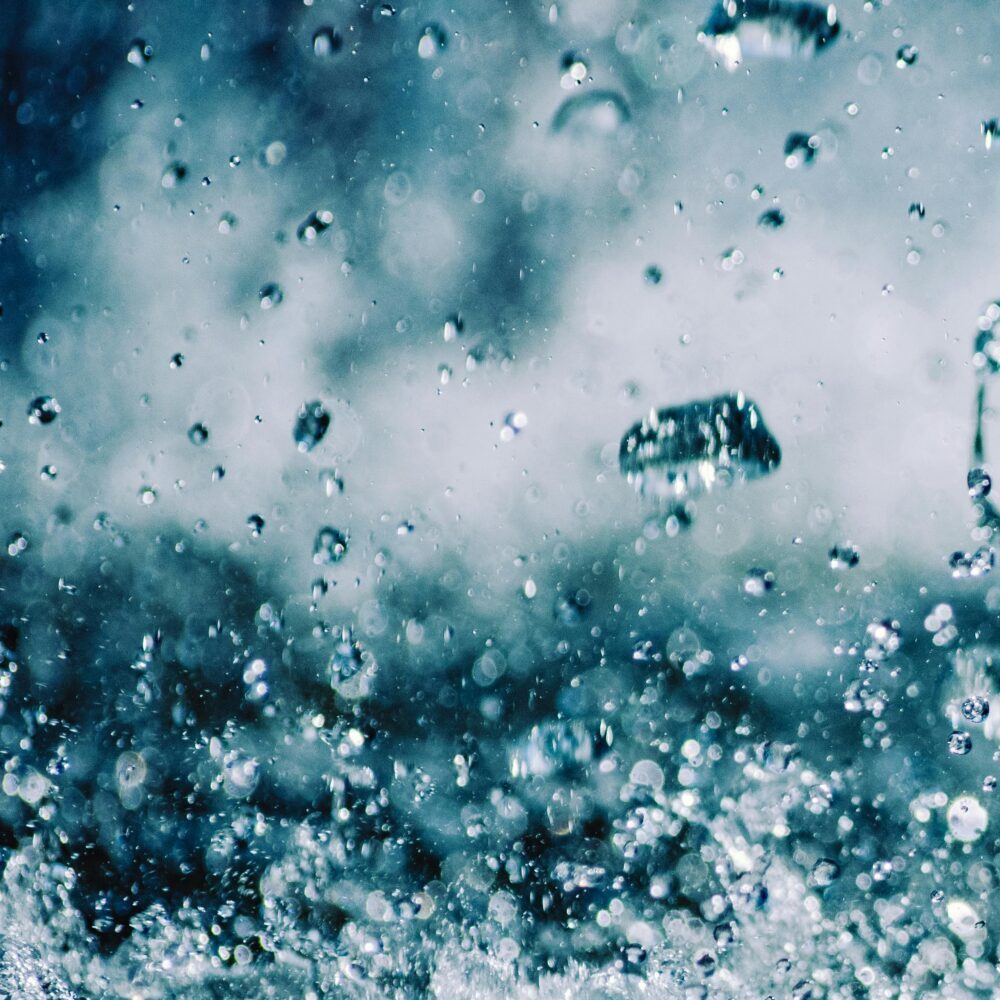Close-up of dynamic water splash with droplets captured mid-air, showcasing motion and energy.