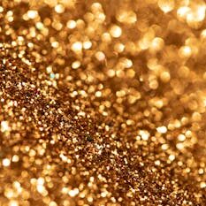 Captivating close-up of golden glitter with sparkling bokeh effect. Perfect for festive themes.